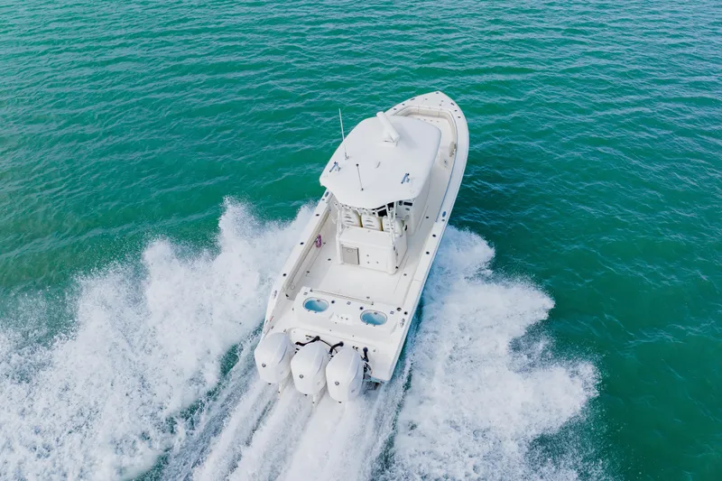 Slide: The Image of 2017 Cobia 344 Center Console boat cruising on open water. - 23