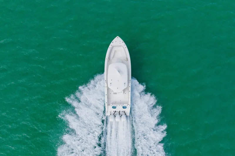 Slide: The Image of Aerial view of 2017 Cobia 344 Center Console boat cruising on turquoise water. - 24