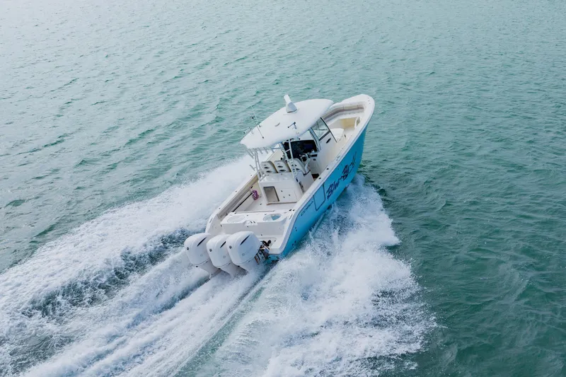 Slide: The Image of 2017 Cobia 344 Center Console boat cruising on open water. - 25