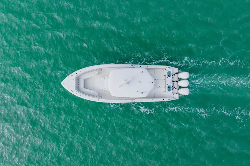 Slide: The Image of Aerial view of 2017 Cobia 344 Center Console boat on turquoise water. - 27