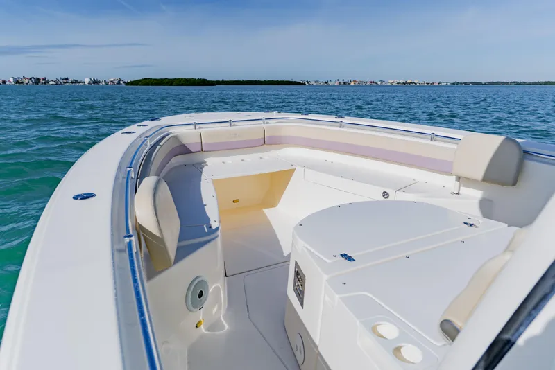 Slide: The Image of 2017 Cobia 344 Center Console boat on calm blue waters, featuring spacious seating. - 28