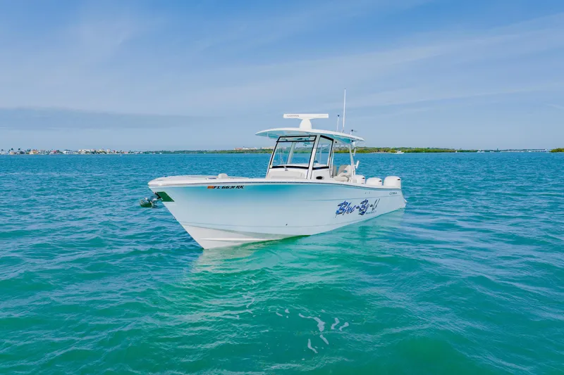 Slide: The Image of 2017 Cobia 344 Center Console boat on clear blue water under a sunny sky. - 3