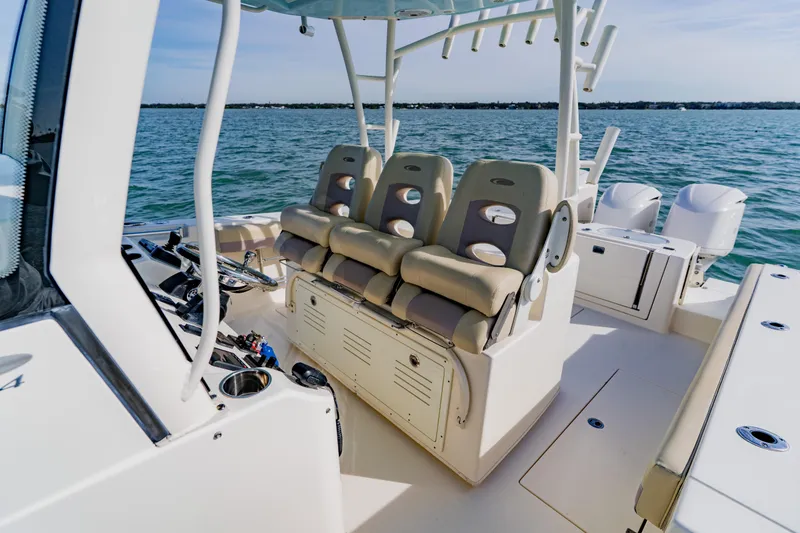 Slide: The Image of 2017 Cobia 344 Center Console boat interior with seating and ocean view. - 31