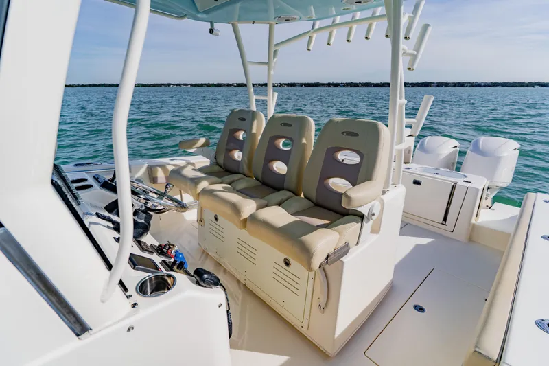 Slide: The Image of 2017 Cobia 344 Center Console boat interior with seating and ocean view. - 32