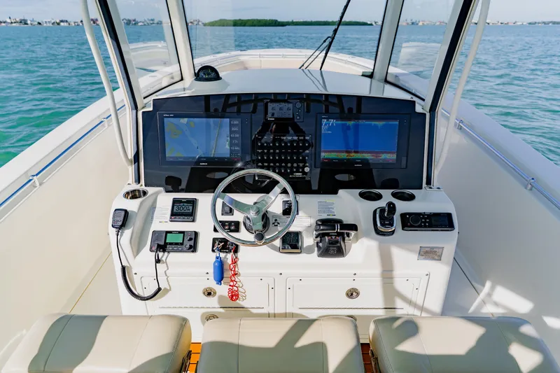 Slide: The Image of 2017 Cobia 344 Center Console boat dashboard with navigation screens and controls. - 35