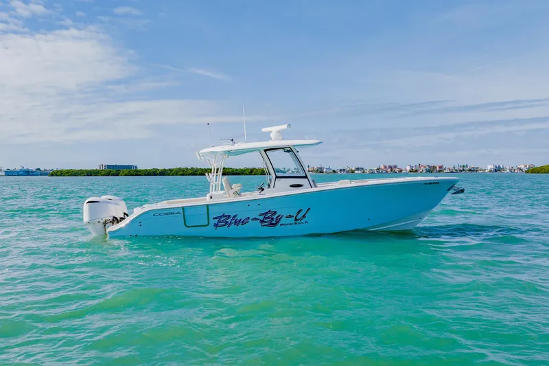 Slide: The Image of 2017 Cobia 344 Center Console boat on turquoise water under blue sky. - 4