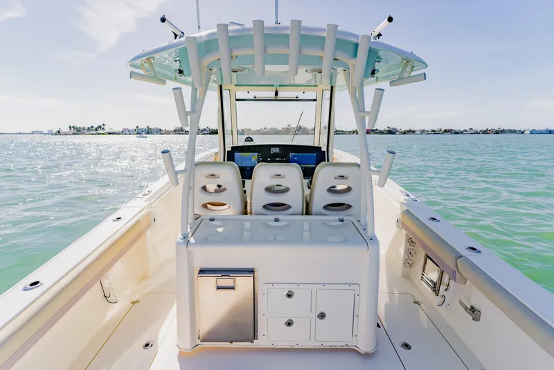 Slide: The Image of 2017 Cobia 344 Center Console boat on calm waters, featuring spacious deck and seating. - 40