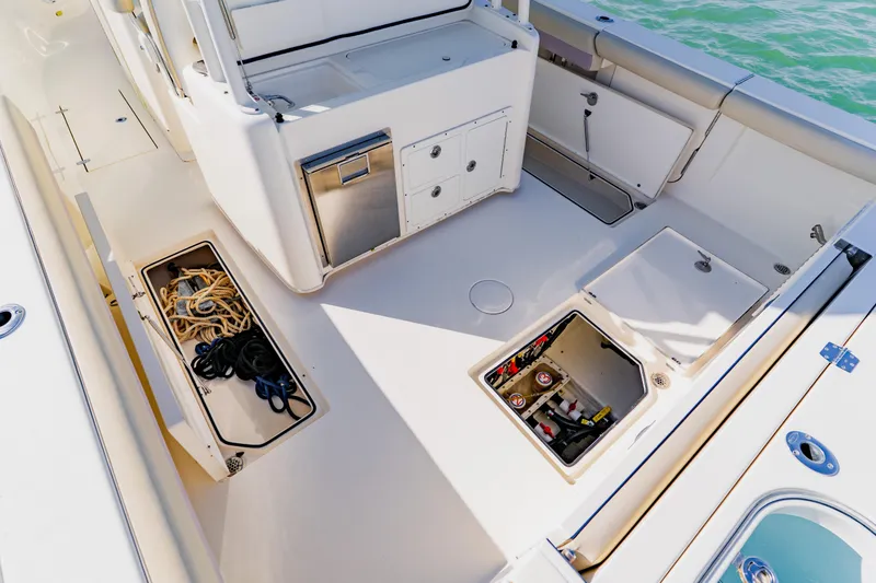 Slide: The Image of 2017 Cobia 344 Center Console boat deck with storage compartments and equipment. - 43