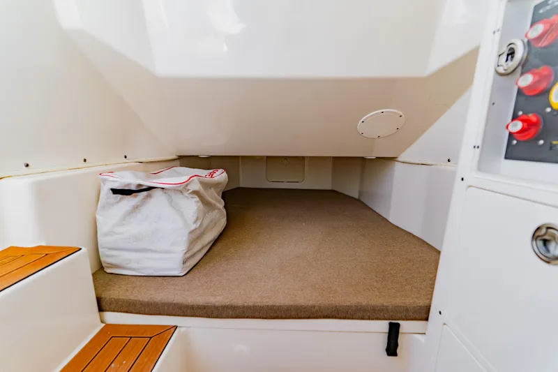 Slide: The Image of 2017 Cobia 344 Center Console cabin interior with storage bag and control panel. - 45