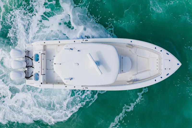 Slide: The Image of Overhead view of 2017 Cobia 344 Center Console boat on turquoise water. - 50