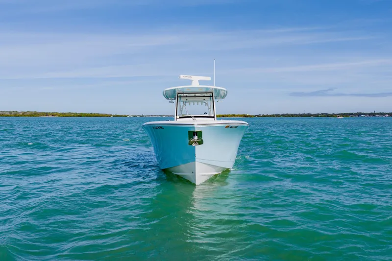 Slide: The Image of 2017 Cobia 344 Center Console boat on clear blue water under a sunny sky. - 8