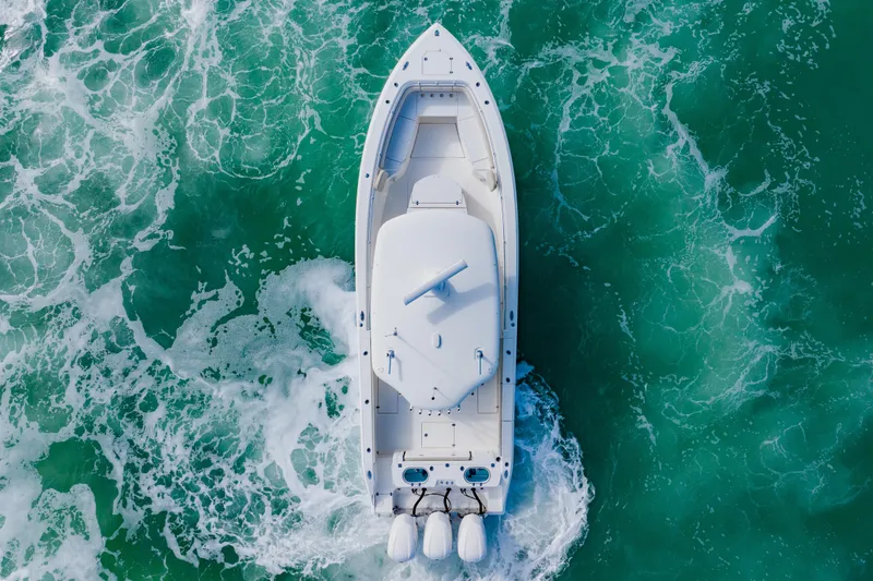 Slide: The Image of Aerial view of 2017 Cobia 344 Center Console boat navigating turquoise waters. - 9