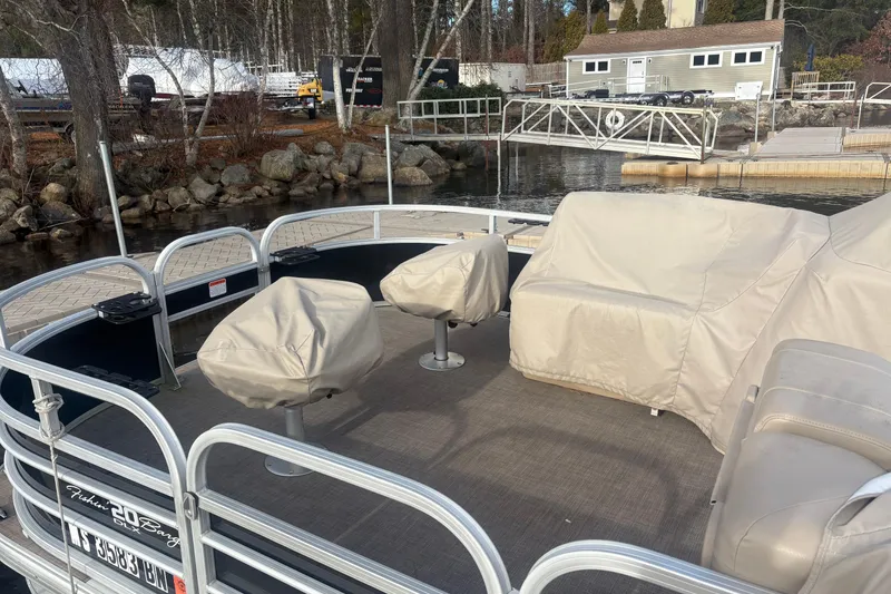 Slide: The Image of 2019 Sun Tracker Fishin' Barge 20 DLX pontoon boat with covered seating at a dock. - 4