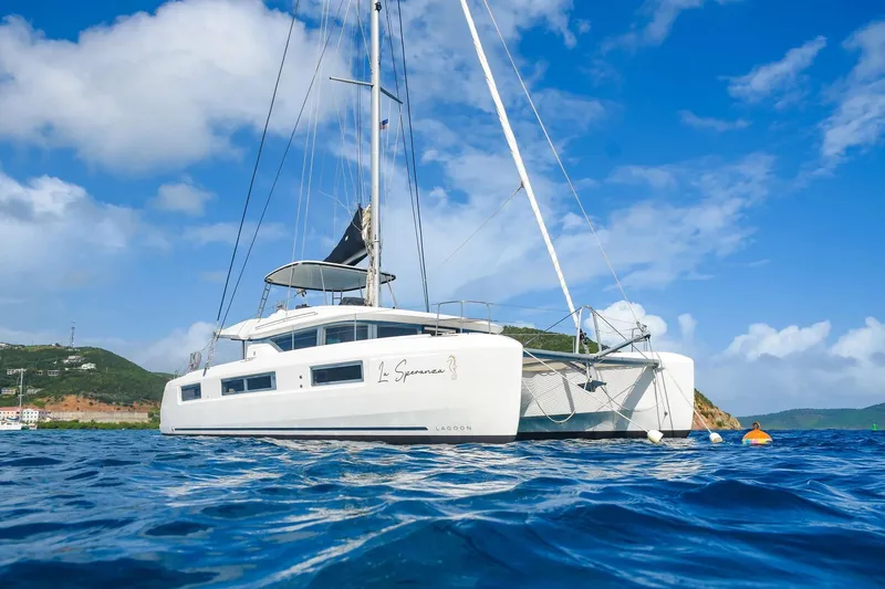 The Image of 2021 Lagoon 50 catamaran sailing on clear blue waters under a bright sky. - 0