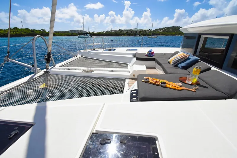 Slide: The Image of Luxurious 2021 Lagoon 50 catamaran deck with comfortable seating and scenic ocean view. - 15