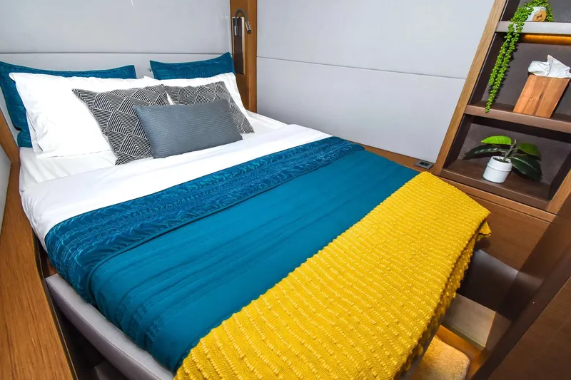 Slide: The Image of Luxurious bedroom interior on a 2021 Lagoon 50 yacht with vibrant bedding and modern decor. - 24