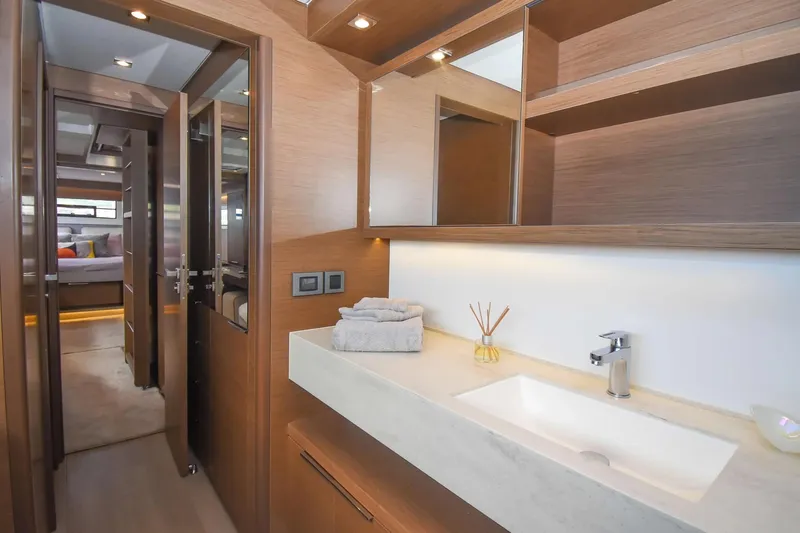 Slide: The Image of Luxurious bathroom interior on 2021 Lagoon 50 yacht, featuring modern sink and wooden cabinetry. - 26