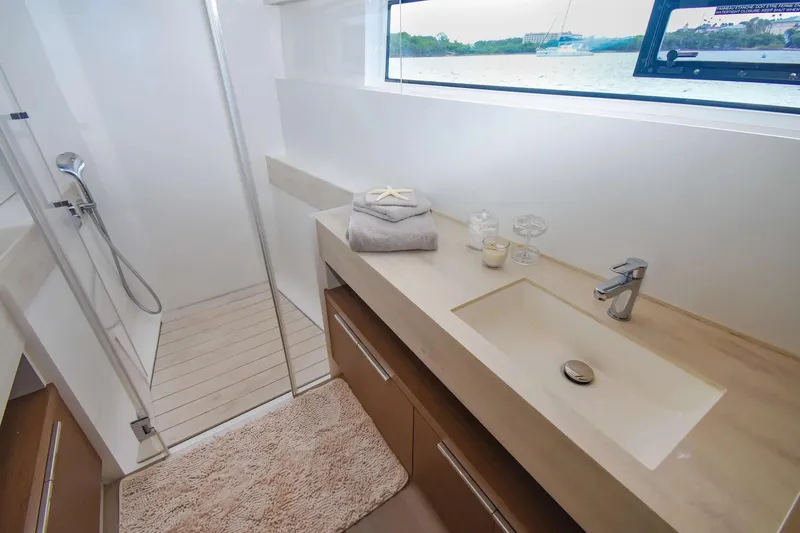Slide: The Image of Luxurious bathroom in 2021 Lagoon 50 yacht with modern fixtures and scenic window view. - 28
