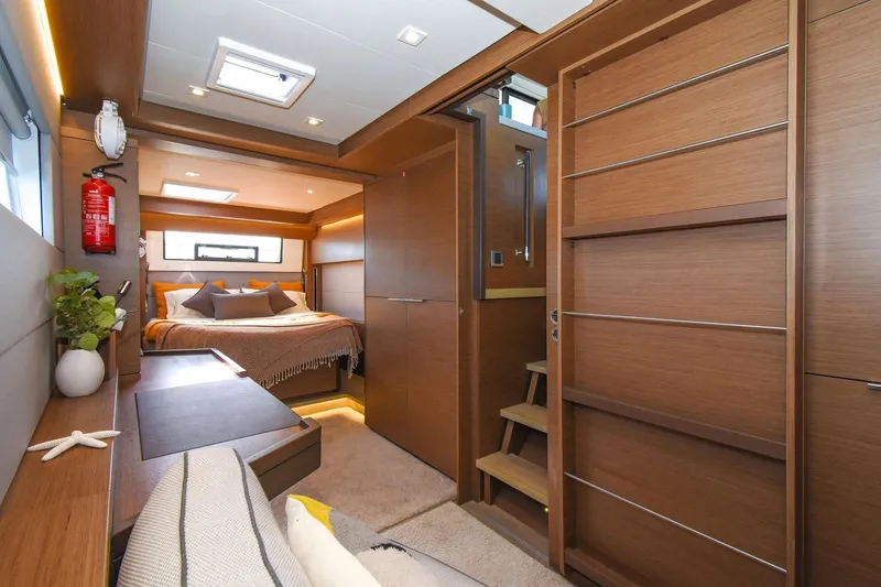 Slide: The Image of Luxurious interior of 2021 Lagoon 50 yacht with cozy bedroom and modern wood finishes. - 35