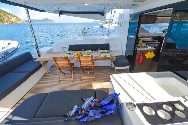 Slide: The Image of Luxurious Lagoon 50 catamaran deck with dining setup, ocean view, and snorkeling gear. - 48