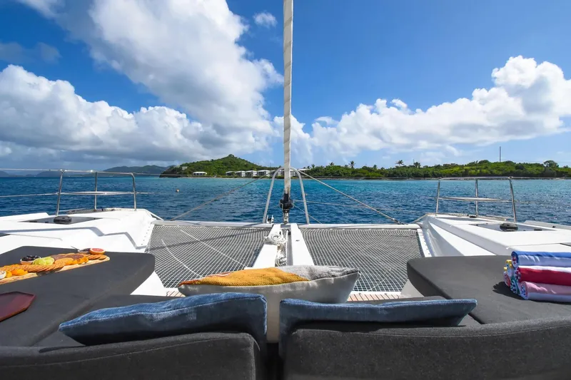 Slide: The Image of Luxurious 2021 Lagoon 50 catamaran with scenic ocean view and comfortable deck seating. - 51