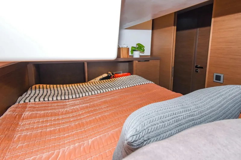 Slide: The Image of Cozy bedroom interior of 2021 Lagoon 50 yacht with modern wood finish. - 53