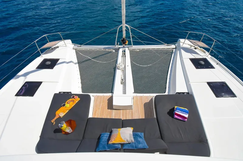 Slide: The Image of Luxurious 2021 Lagoon 50 catamaran deck with sun loungers and ocean view. - 6