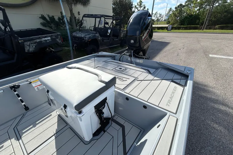 Slide: The Image of 2026 Tracker Bass Tracker Classic CC boat with Mercury engine, parked outdoors. - 4