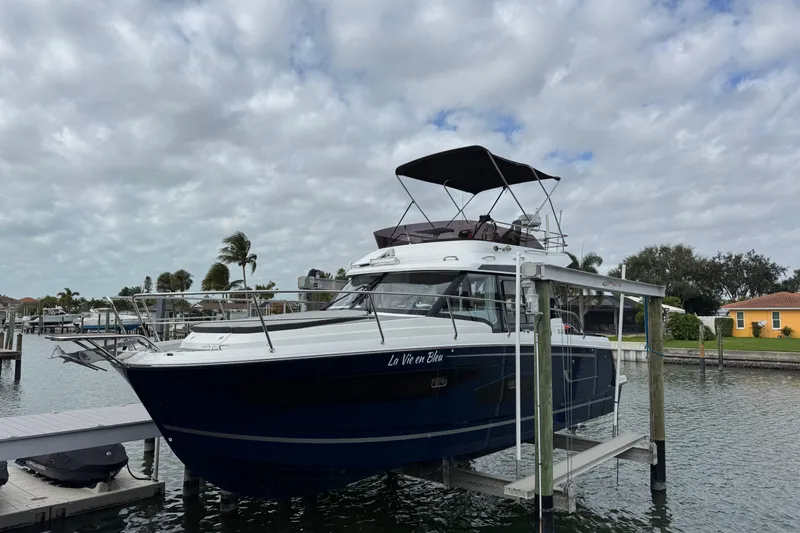The Image of 2022 Jeanneau NC Weekender 1095 boat docked under cloudy sky. - 1