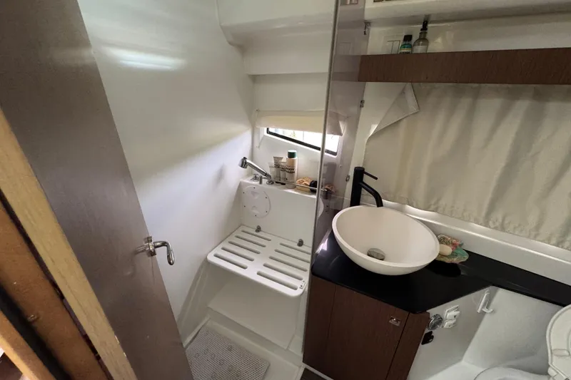 Slide: The Image of 2022 Jeanneau NC Weekender 1095 bathroom with modern sink and shower area. - 15