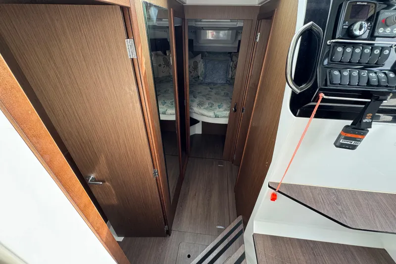 Slide: The Image of 2022 Jeanneau NC Weekender 1095 interior with wood finish and control panel. - 18