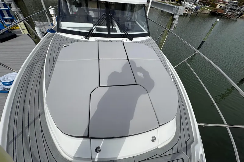 Slide: The Image of 2022 Jeanneau NC Weekender 1095 boat deck with cushioned seating, docked by the water. - 19