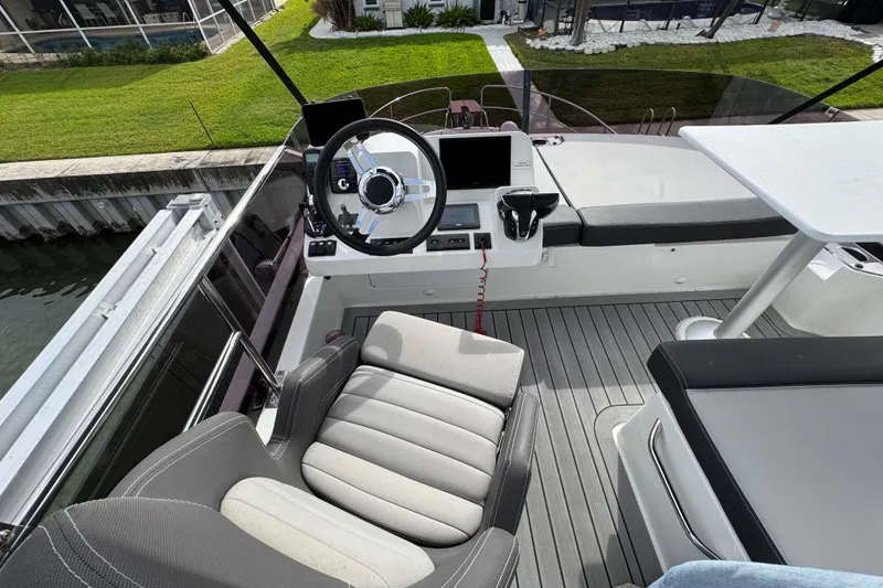 Slide: The Image of 2022 Jeanneau NC Weekender 1095 helm station with modern controls and seating. - 22