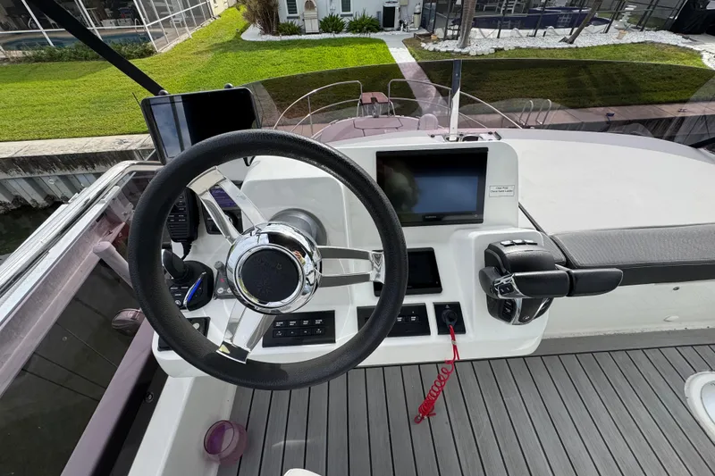 Slide: The Image of Steering console of 2022 Jeanneau NC Weekender 1095 with modern controls and navigation display. - 23