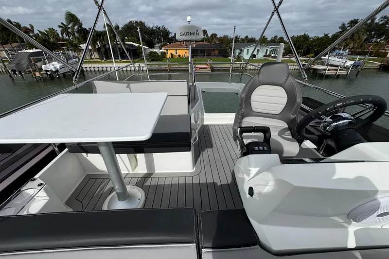 Slide: The Image of 2022 Jeanneau NC Weekender 1095 boat interior with seating and steering area. - 25