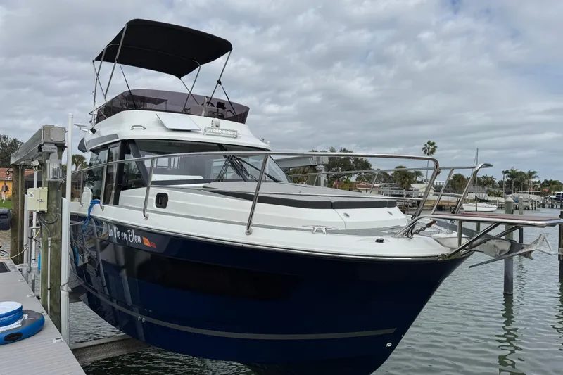 Slide: The Image of 2022 Jeanneau NC Weekender 1095 docked at marina under cloudy sky. - 3