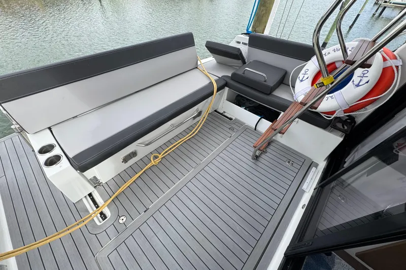 Slide: The Image of 2022 Jeanneau NC Weekender 1095 boat deck with seating and life preserver. - 5
