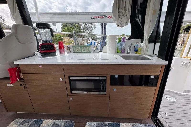 Slide: The Image of Interior of 2022 Jeanneau NC Weekender 1095 with kitchenette and appliances. - 8