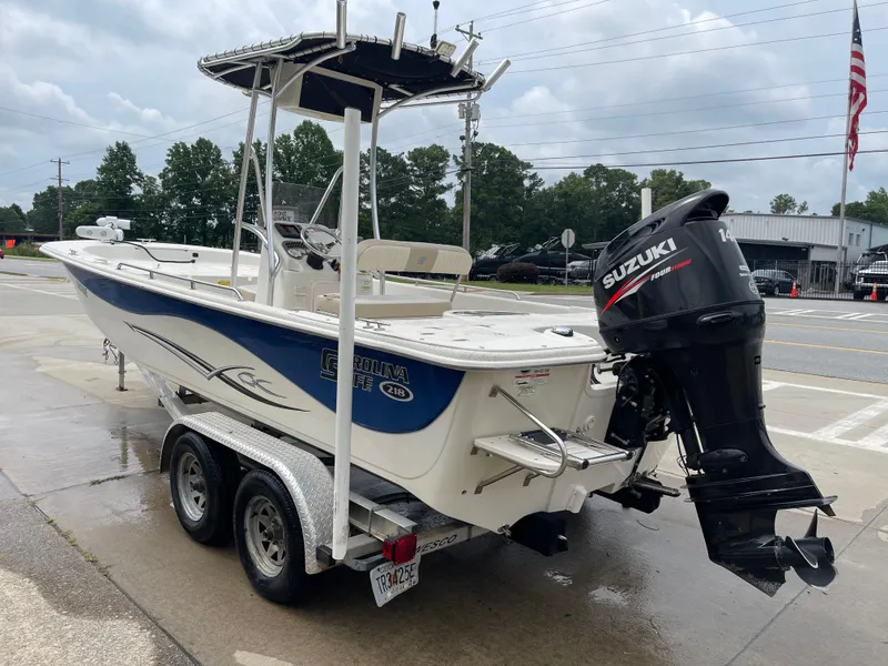 Slide: The Image of 2014 Carolina Skiff 218 DLV boat with Suzuki outboard motor. - 18