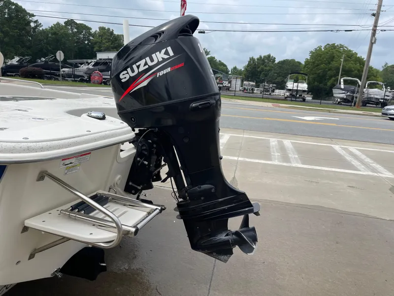 Slide: The Image of Suzuki outboard motor on a 2014 Carolina Skiff 218 DLV boat. - 19