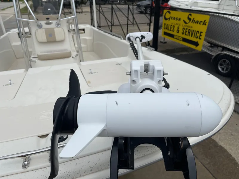 Slide: The Image of 2014 Carolina Skiff 218 DLV with outboard motor, sales area in background. - 23