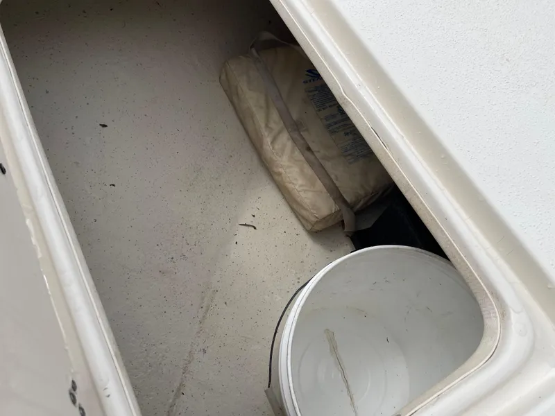 Slide: The Image of Storage compartment in 2014 Carolina Skiff 218 DLV with bucket and bag. - 25