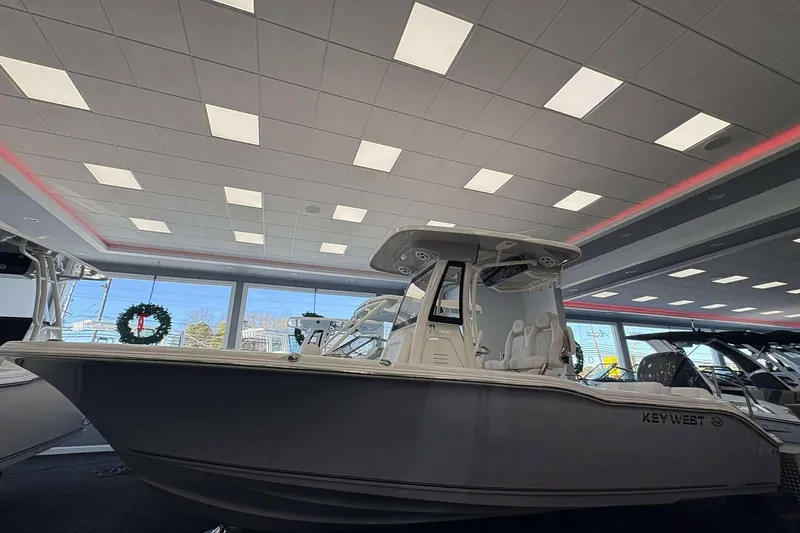 The Image of 2026 Key West 239 FS boat displayed in a showroom with festive decor. - 1