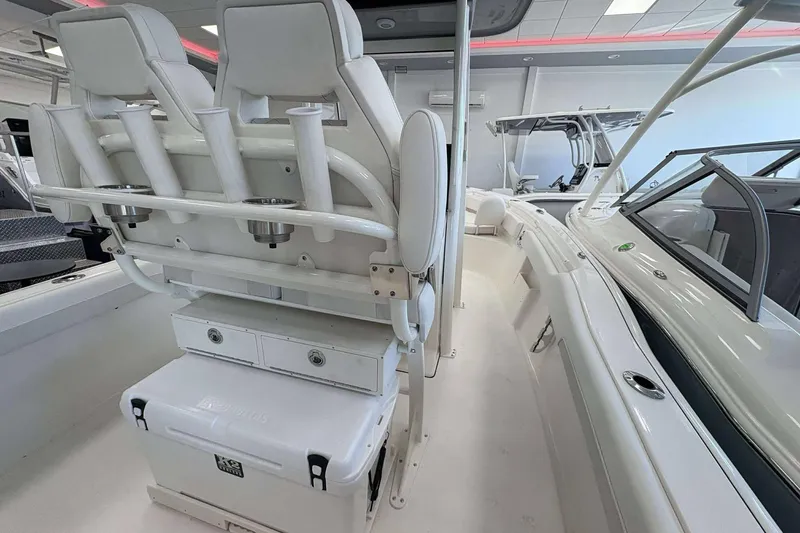 Slide: The Image of 2026 Key West 239 FS boat interior with seating and rod holders. - 11