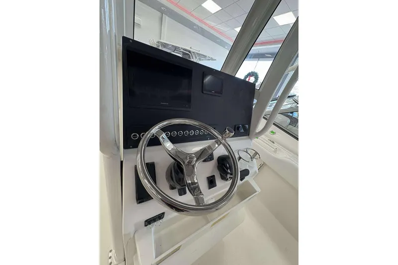 Slide: The Image of 2026 Key West 239 FS boat helm with steering wheel and control panel. - 17