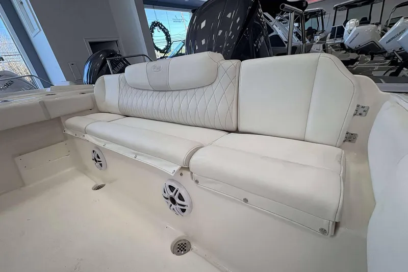 Slide: The Image of 2026 Key West 239 FS boat interior with white cushioned seating and built-in speakers. - 19