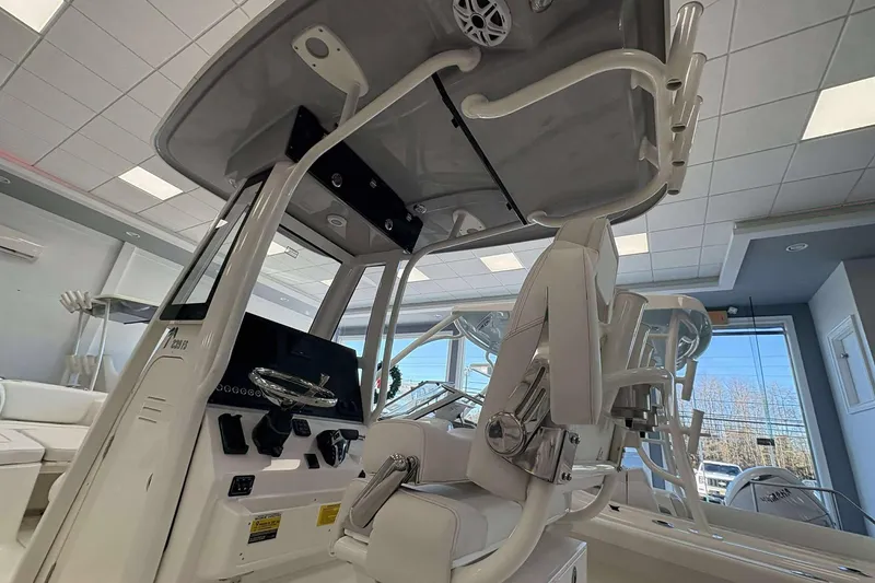 Slide: The Image of 2026 Key West 239 FS boat interior with modern helm and seating in showroom. - 3