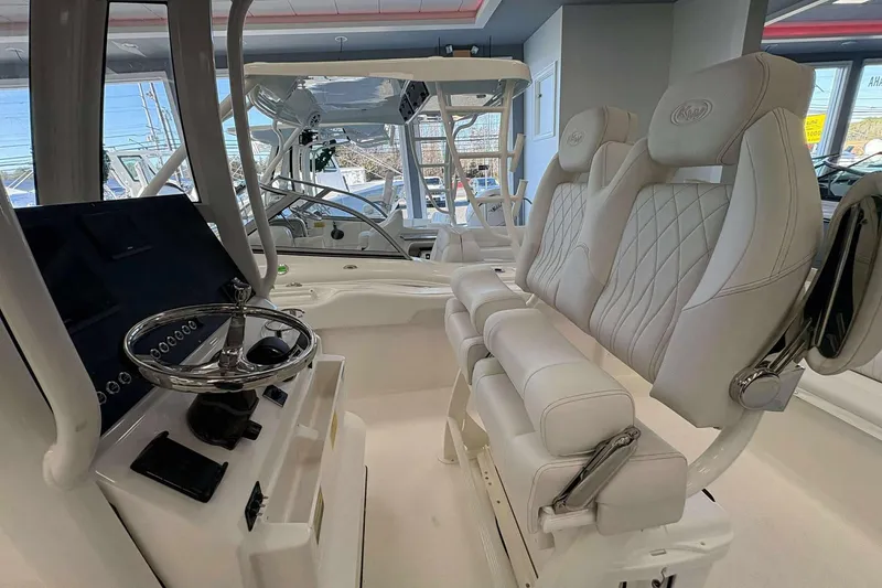 Slide: The Image of 2026 Key West 239 FS boat interior with luxurious seating and modern steering console. - 5