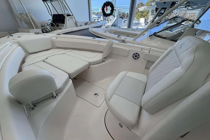 Slide: The Image of 2026 Key West 239 FS boat interior with white seating and modern design. - 7