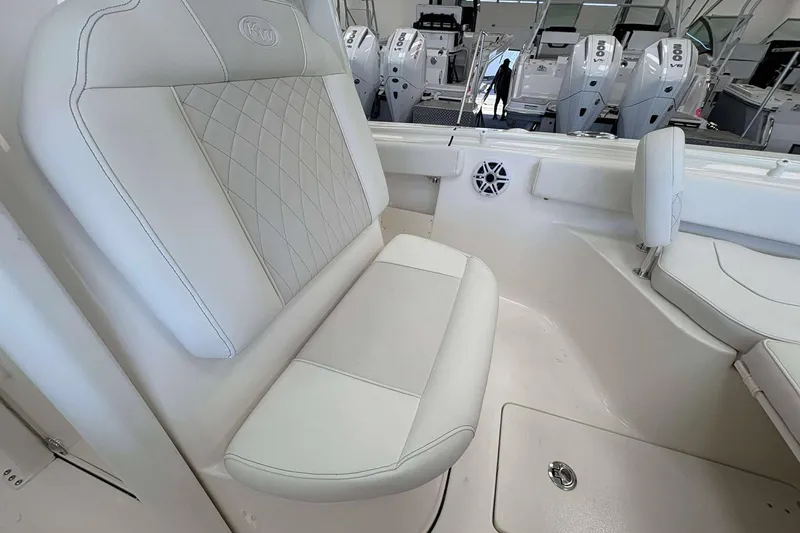 Slide: The Image of 2026 Key West 239 FS boat interior with white cushioned seating and modern design. - 8